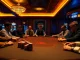 Players strategizing during a high-stakes poker game at U 888 casino, with vibrant ambiance and atmosphere.