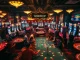 Experience the exciting gambling ambiance of https://tylekeouytin.com/, with players at vibrant casino tables and slot machines.